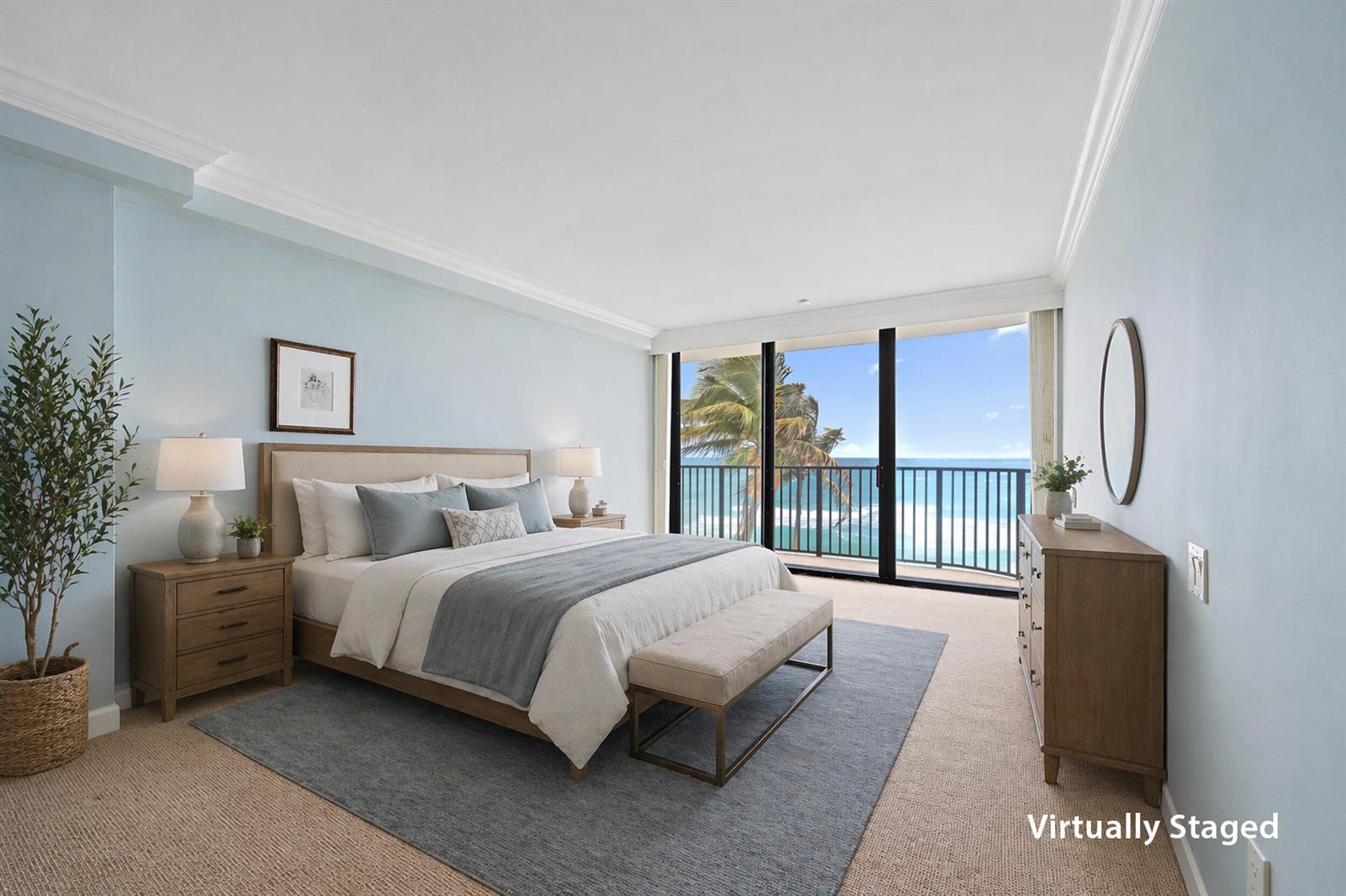 A virtually staged bedroom features a king bed, wood furniture, and a balcony overlooking the ocean — 200 Beach Road # 202, Tequesta FL 33469, TEQUESTA, FL