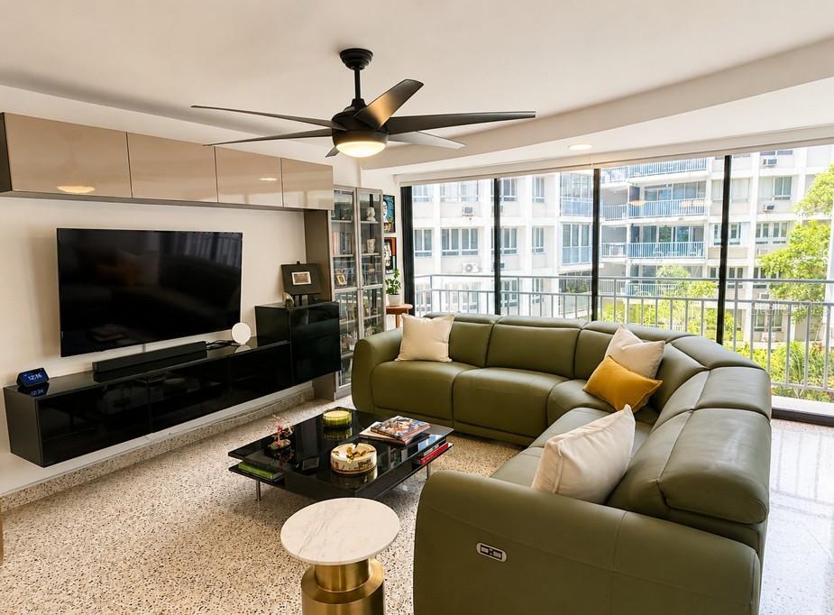 A living room features a green sectional sofa, a black media console, and a ceiling fan — 185–187 PINE GROVE STREET, CAROLINA, PR
