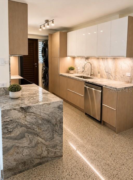 A modern kitchen features light wood cabinetry, white upper cabinets, and a stone waterfall island — 185–187 PINE GROVE STREET, CAROLINA, PR