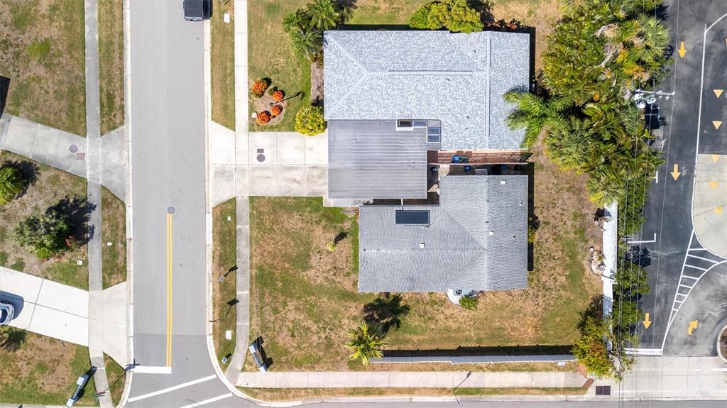 An aerial view shows a single-story house with a grey roof on a corner lot — 2463 TERRY LANE, SARASOTA, FL