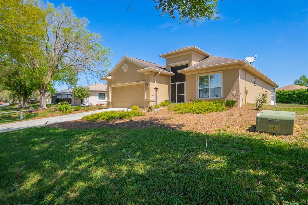 A tan, single-story suburban house with a two-car garage and a front lawn — 2163 N BRENTWOOD CIRCLE, LECANTO, FL