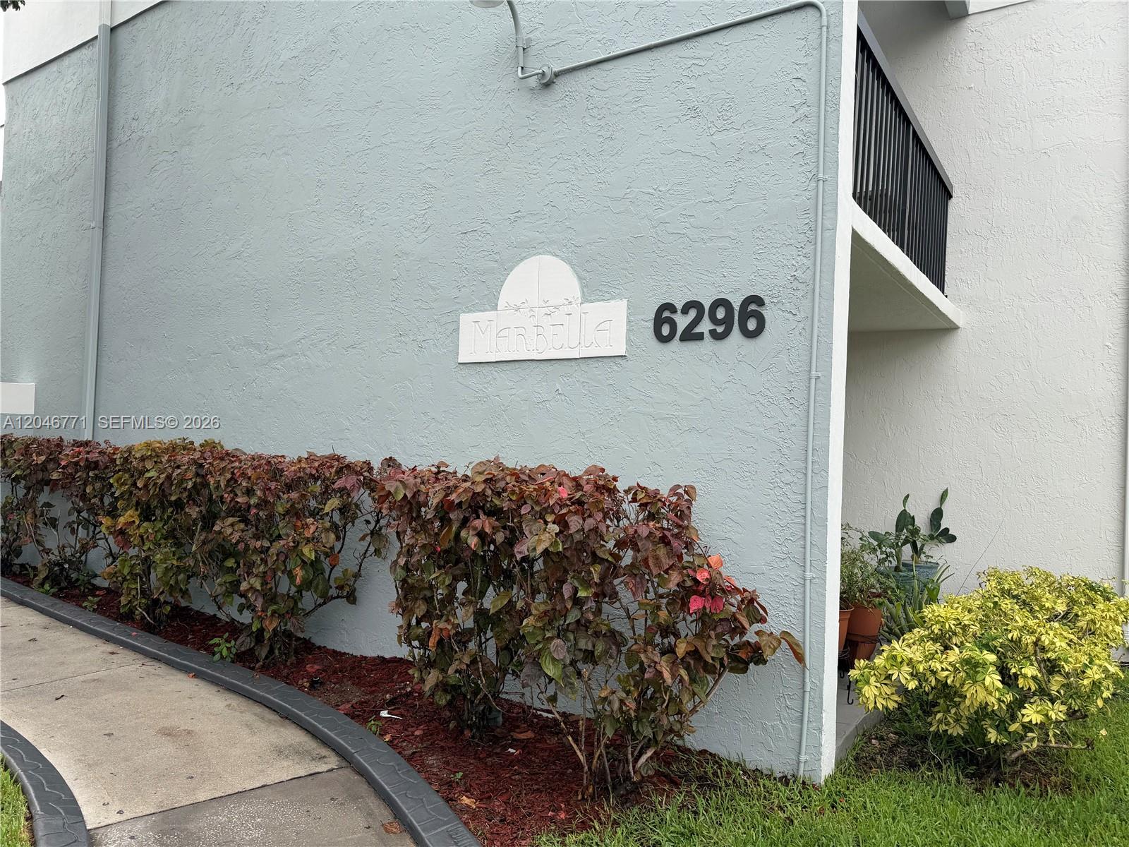 A light blue exterior wall features the name Marbella and the number 6296 — HIALEAH, FL