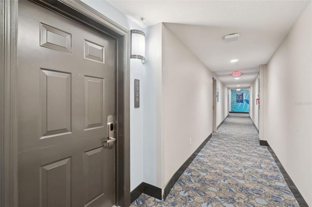 A gray apartment door with the number 1726 is located in a carpeted building hallway — 14501 GROVE RESORT AVENUE UNIT 1726, WINTER GARDEN, FL