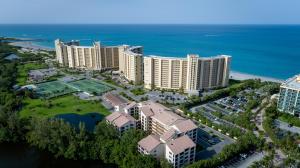 An aerial view shows large beachfront apartment complexes with tennis courts and surrounding parking lots — 500 Ocean Trail Way # 506, Jupiter FL 33477, JUPITER, FL