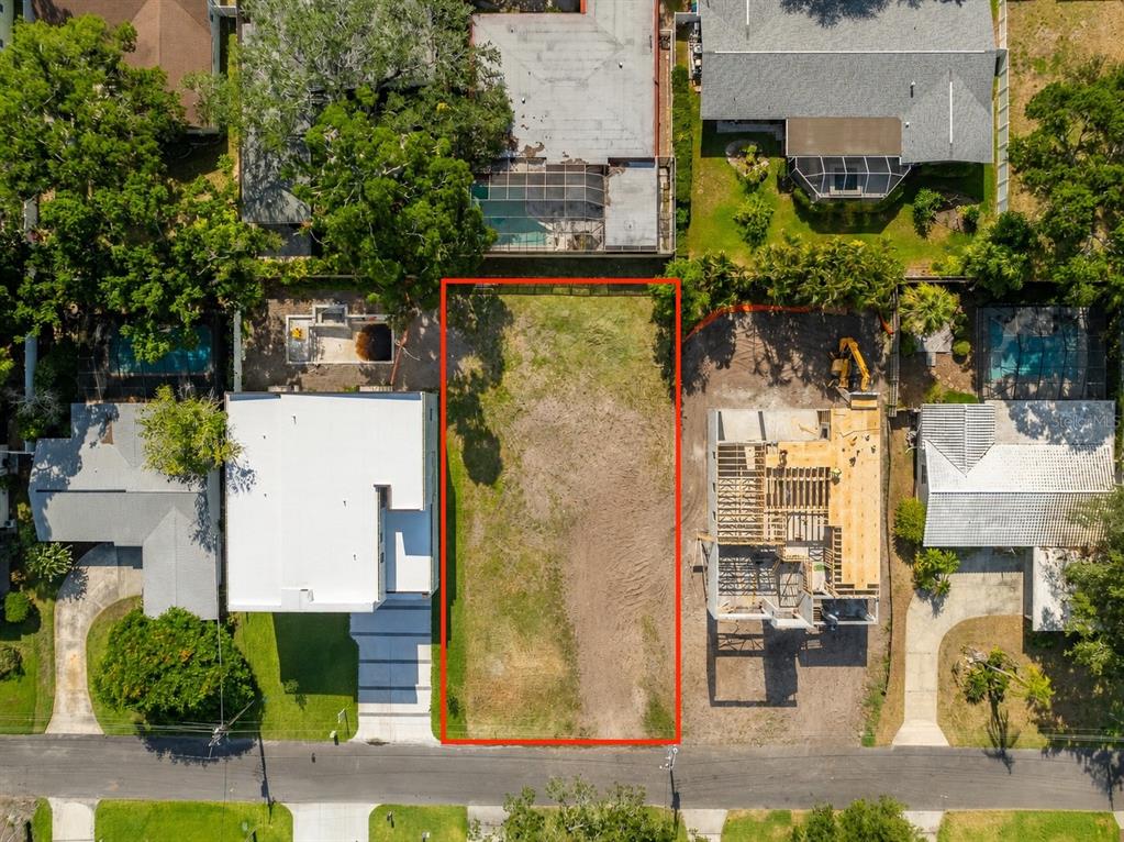 An aerial view shows a vacant rectangular lot situated between two residential properties — 208 S TREASURE DRIVE, TAMPA, FL