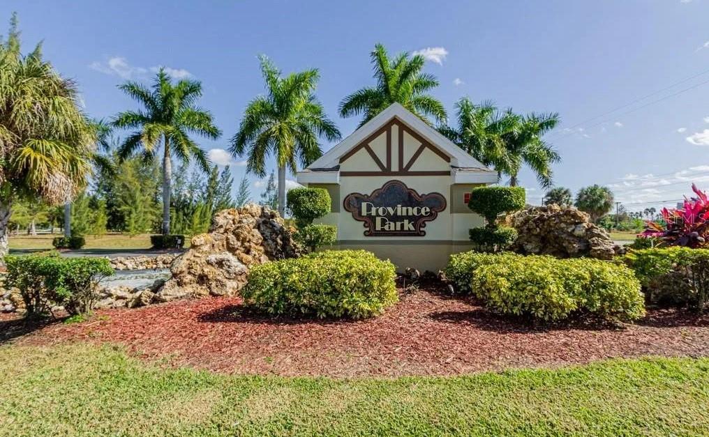 A stone-accented entrance sign for Province Park stands surrounded by palm trees and landscaping — 4263 LIRON AVENUE UNIT 101, FORT MYERS, FL