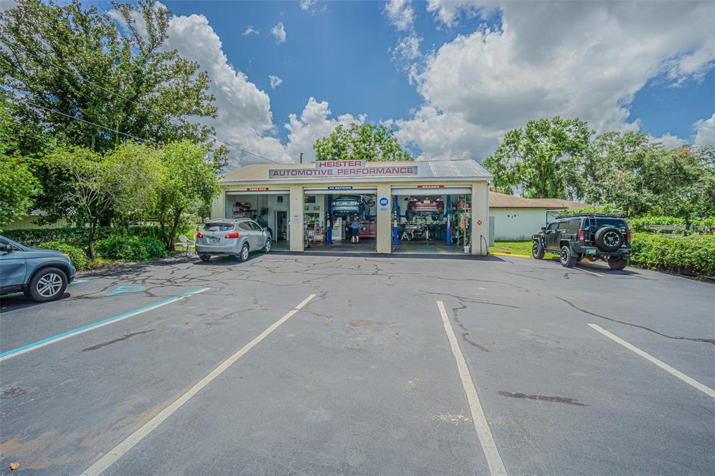 The exterior of an automotive repair shop features three service bays and a paved parking lot — 5924 7TH STREET, ZEPHYRHILLS, FL