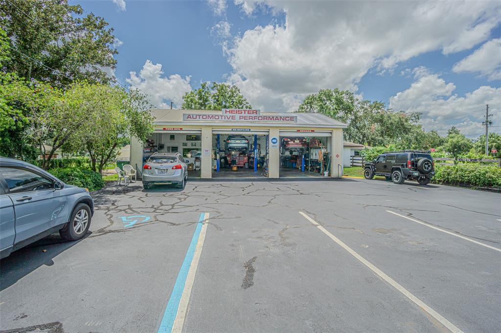 An exterior view of an automotive repair shop with three service bays and a parking lot — 5924 7TH STREET, ZEPHYRHILLS, FL