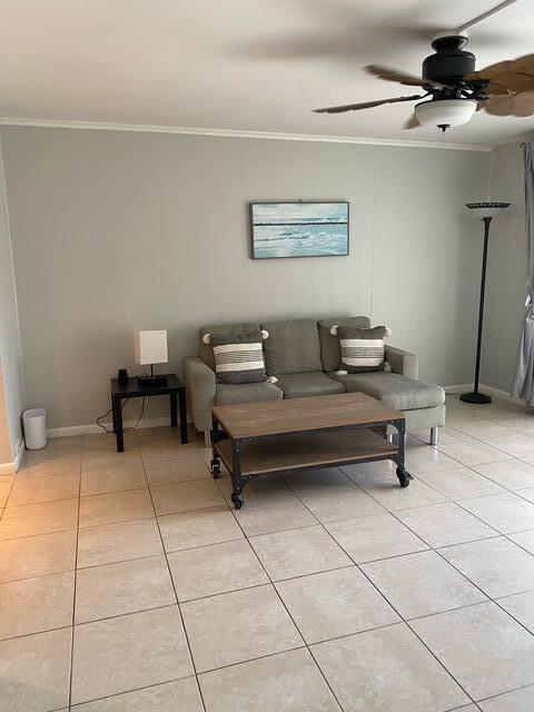A living room features a gray sectional sofa, a wooden coffee table, and tile flooring — 209 SE 6th Street # 4, Boynton Beach FL 33435, BOYNTON BEACH, FL