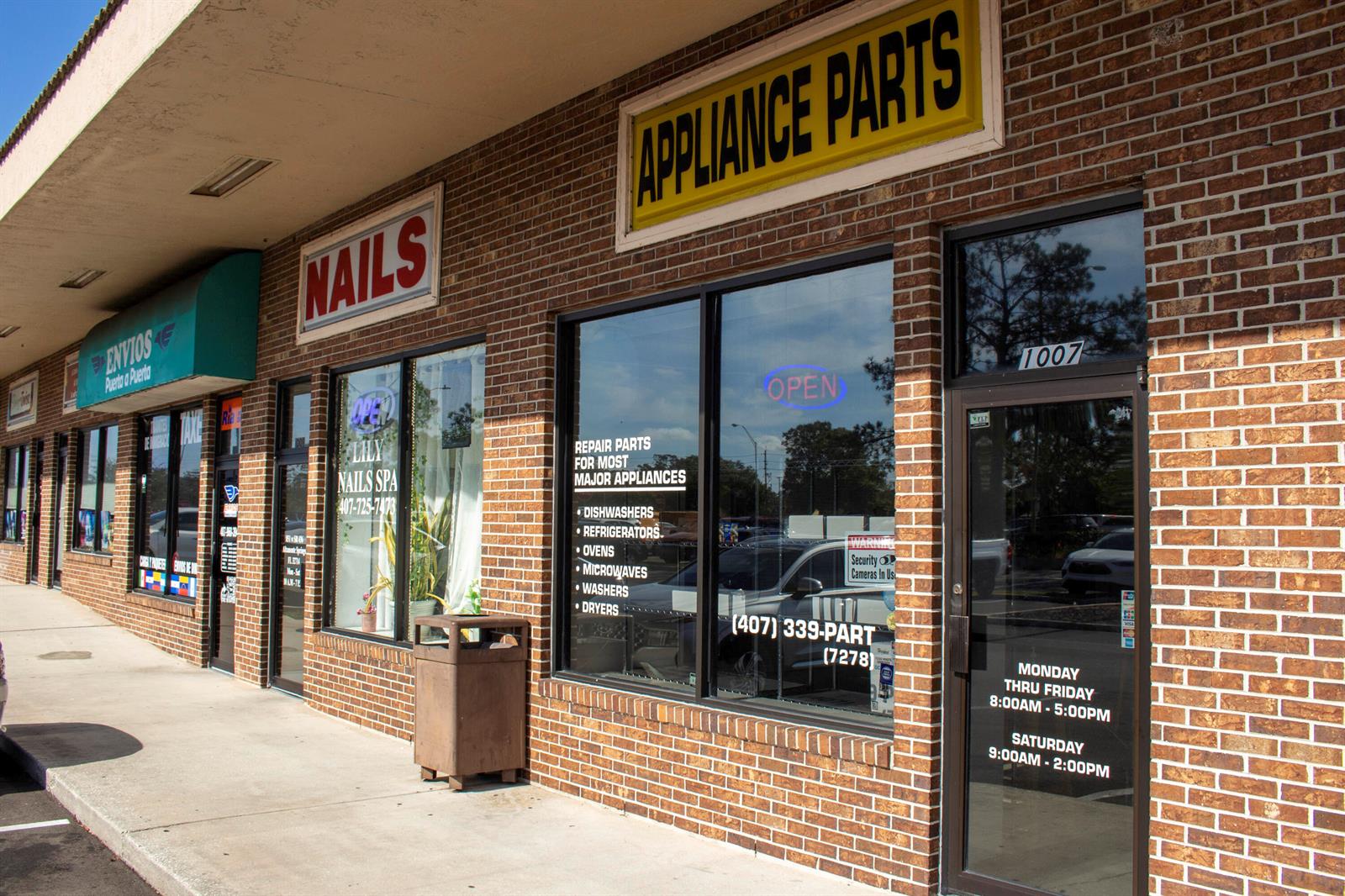 A brick storefront features an appliance parts shop next to a nail salon — 851 W State Rt 436 # 1007, FL 32714, FL