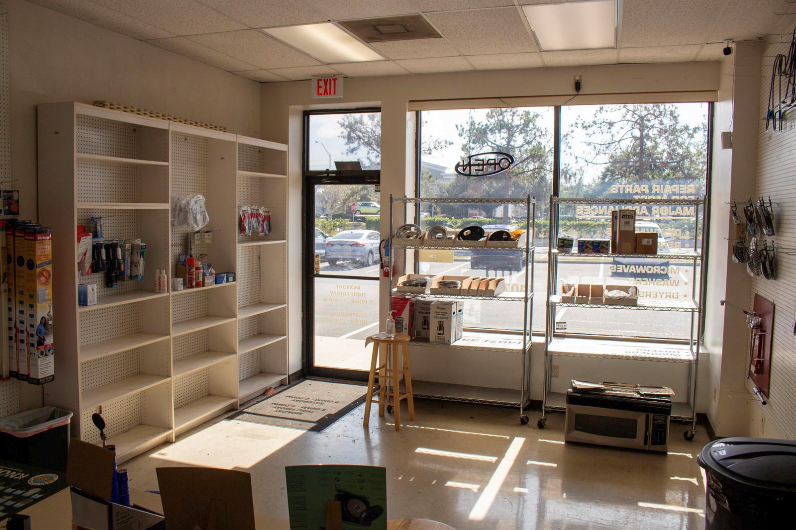 A retail storefront features white shelving units, metal display racks, and a large front window — 851 W State Rt 436 # 1007, FL 32714, FL
