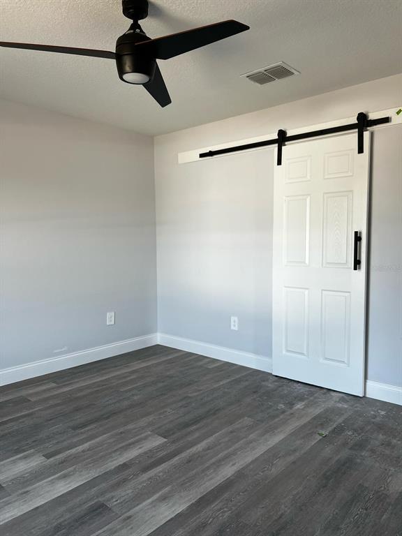 A single-story house with a white stucco exterior, grey brick base, and a two-car garage — 843 W GAGE LANE, DUNNELLON, FL