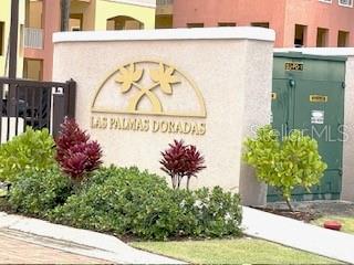 A beige monument sign for Las Palmas Doradas stands in front of a green utility cabinet — CANDELERO DRIVE PALMAS DORADAS UNIT 519, HUMACAO, PR