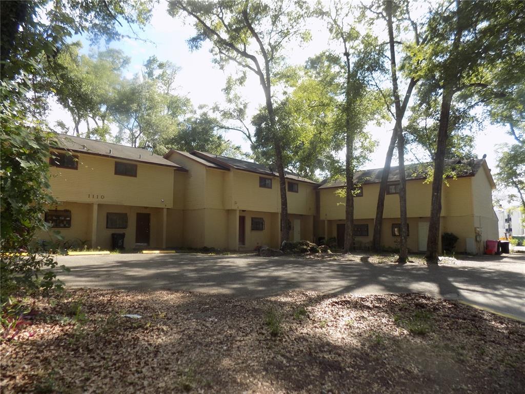A two-story yellow apartment building with a paved parking lot in front — 1110 SW 62 TERRACE UNIT A,B,C,D,E and F, GAINESVILLE, FL