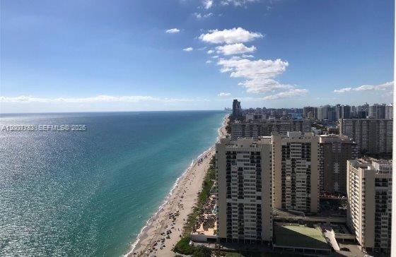 An elevated view of a sandy beach and oceanfront high-rise buildings under a blue sky — 1830 S Ocean Dr # 1705, Hallandale Beach FL 33009, HALLANDALE BEACH, FL
