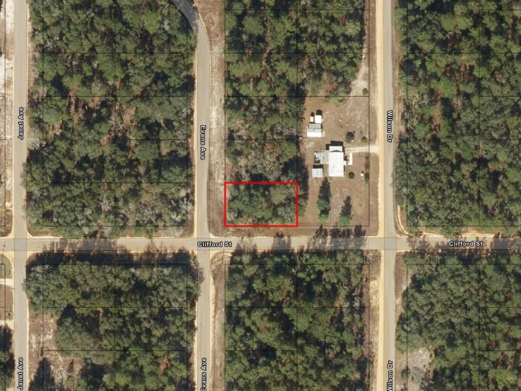 An aerial map view shows a rectangular vacant lot highlighted in red near a street intersection — 0 Evans Avenue, FL 32148, FL