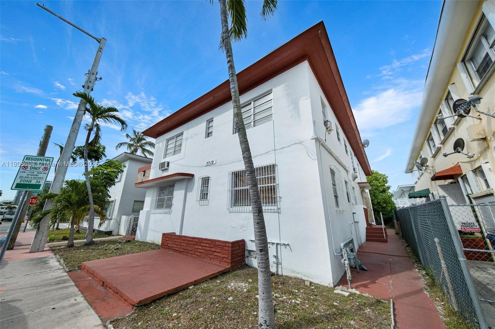 A two-story white building with a red trim roof and a brick patio area — 7712 Byron Ave # 2, Miami Beach FL 33141, MIAMI BEACH, FL