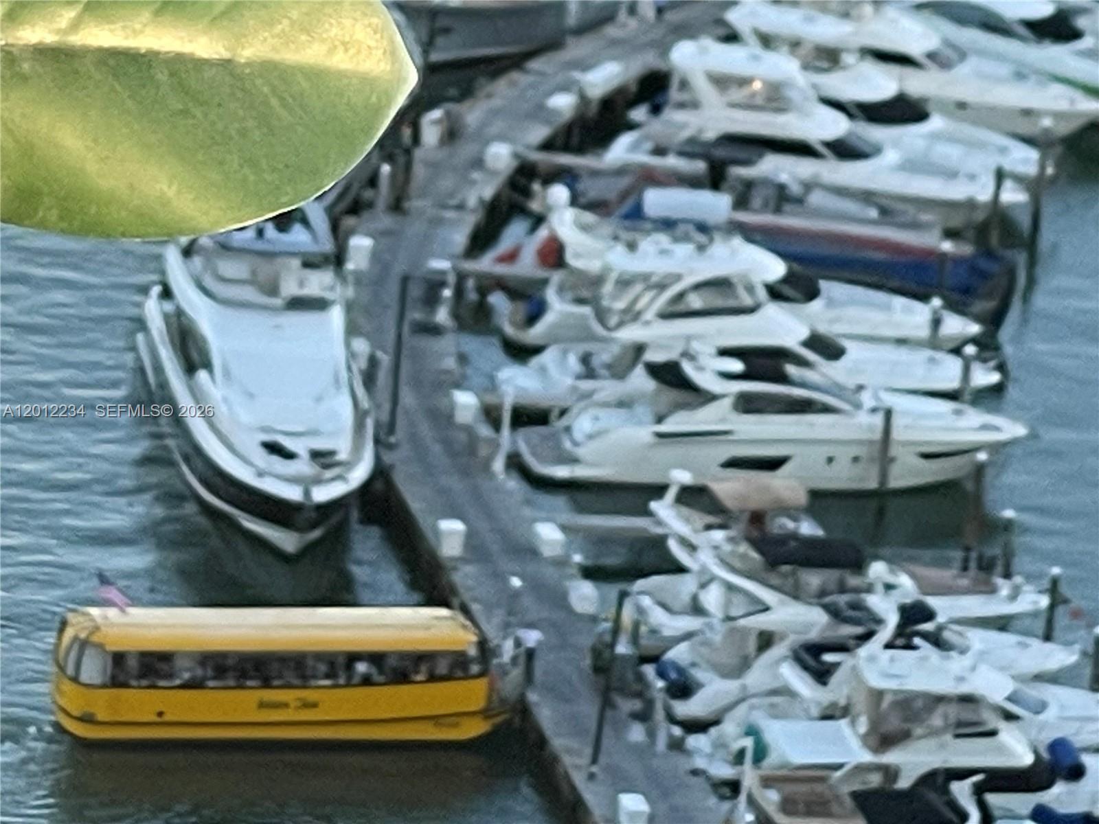 An aerial view shows a yellow boat shaped like a bus docked near several yachts — 1750 N Bayshore Dr # 3403, Miami FL 33132, MIAMI, FL