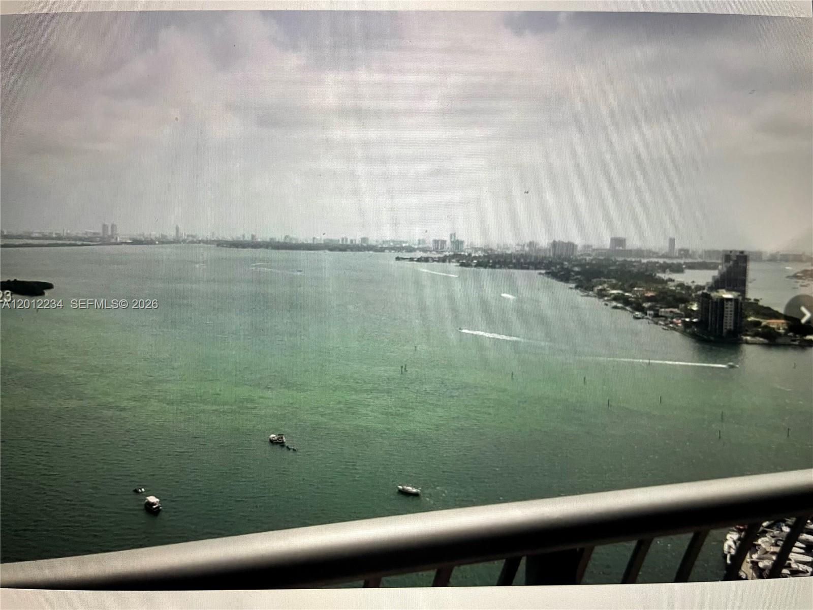An elevated view of a bay with boats and a distant city skyline — 1750 N Bayshore Dr # 3403, Miami FL 33132, MIAMI, FL