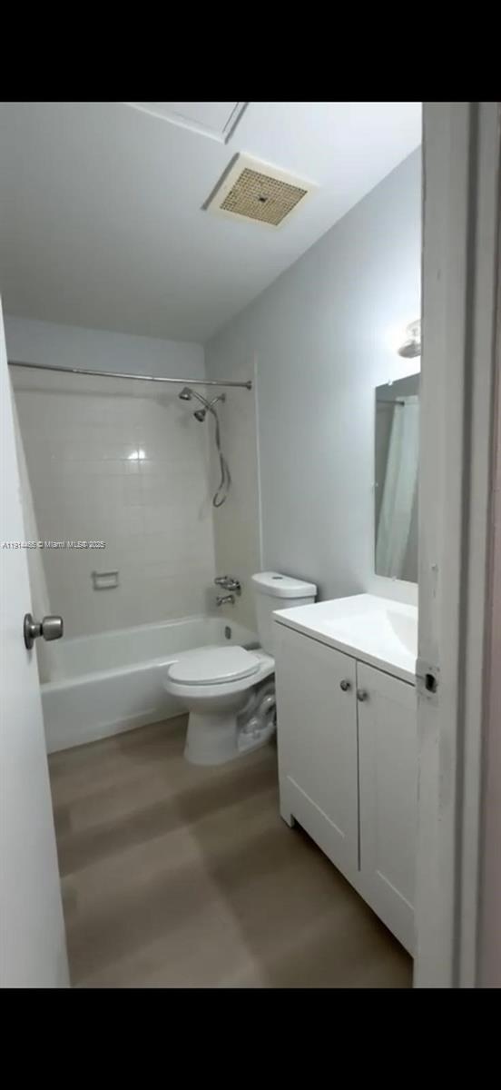 A bathroom with a white vanity, a toilet, and a shower-tub combination with light flooring — 17901 NW 68 Ave # 205, Hialeah FL 33015, HIALEAH, FL