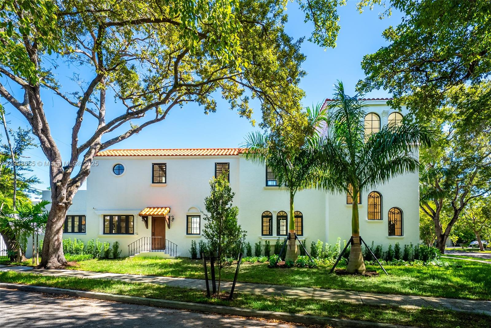A two-story white stucco house features a red tile roof and arched windows — 601 NE 56th St, Miami FL 33137, MIAMI, FL