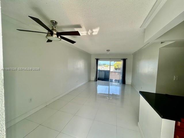 An empty room with white walls, white tile flooring, a ceiling fan, and a balcony — 1725 W 60th St # F316, Hialeah FL 33012, HIALEAH, FL