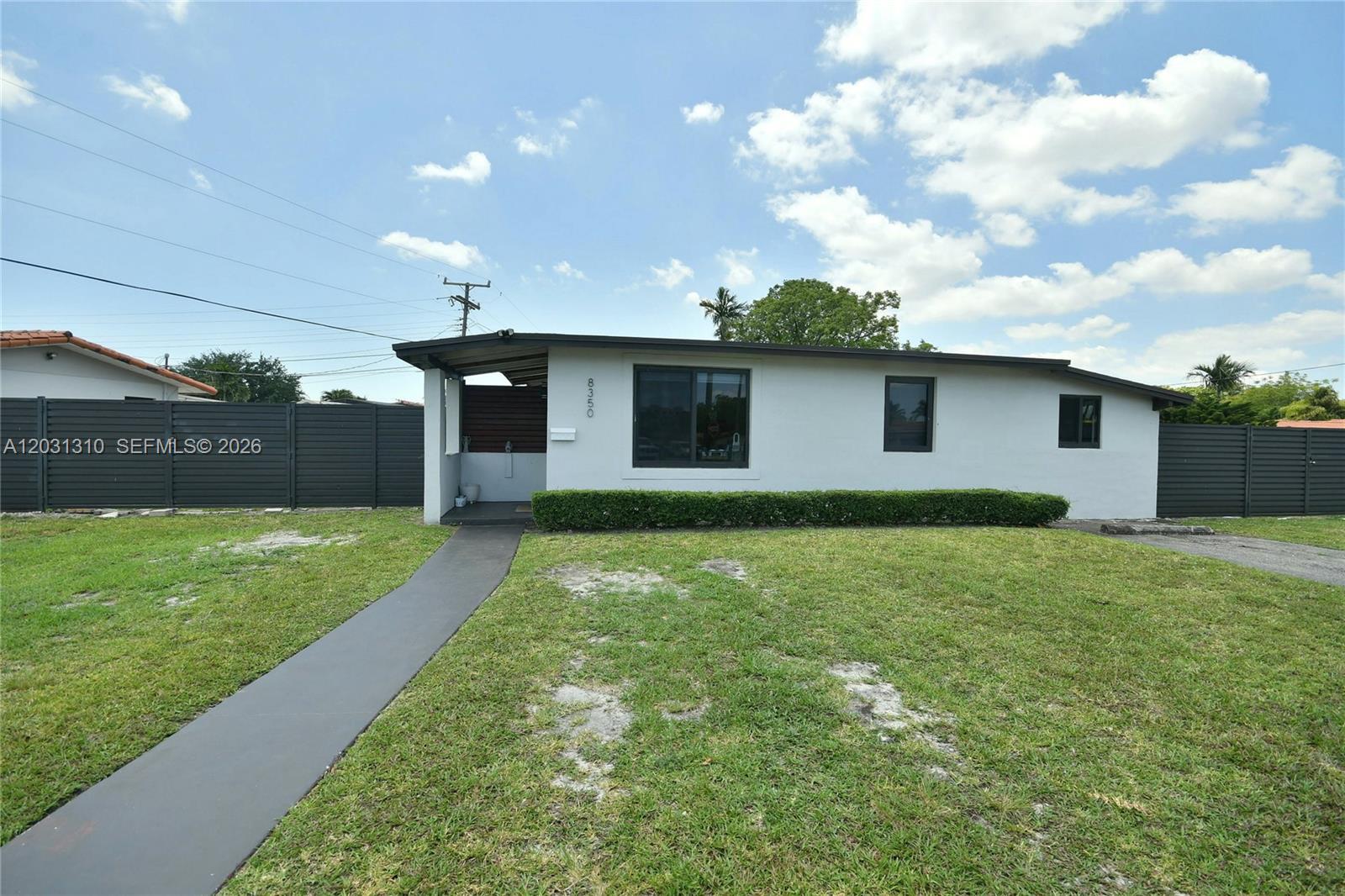 A single-story house with a white exterior, dark trim, and a front walkway — 8350 SW 12th Ter, Miami FL 33144, MIAMI, FL