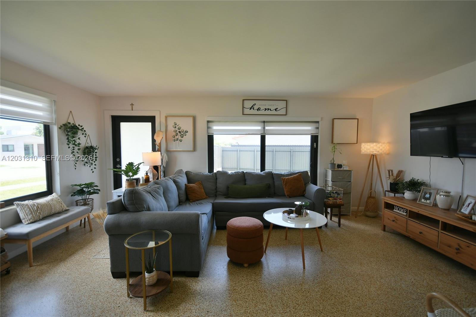 A living room features a grey sectional sofa, a coffee table, and a television console — 8350 SW 12th Ter, Miami FL 33144, MIAMI, FL