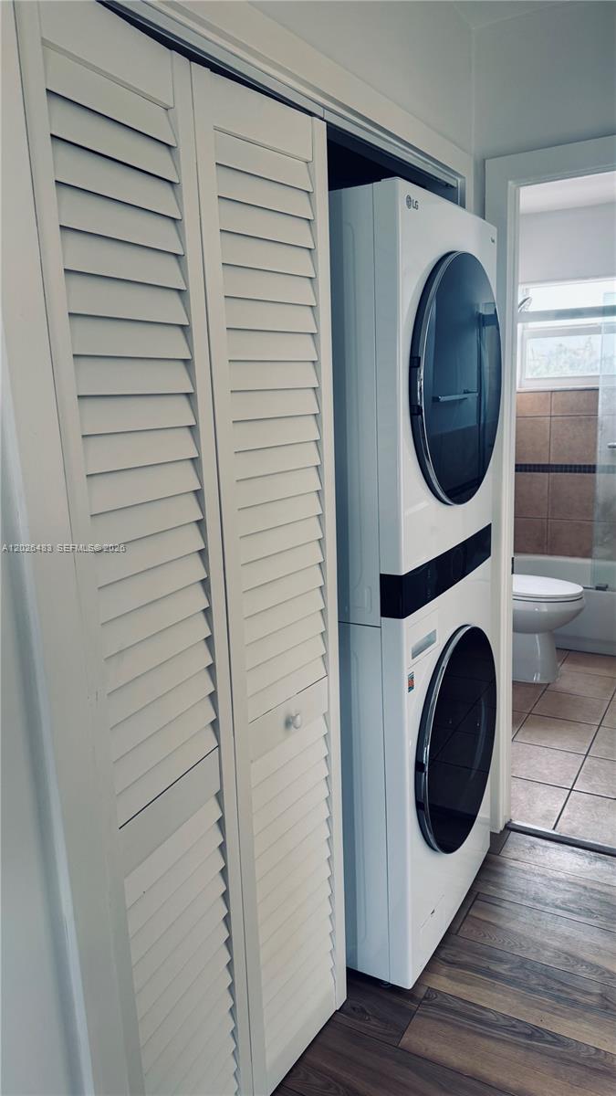 A stacked LG washer and dryer unit sits next to a louvered closet door — 363 Washington Ave # 52, Miami Beach FL 33139, MIAMI BEACH, FL