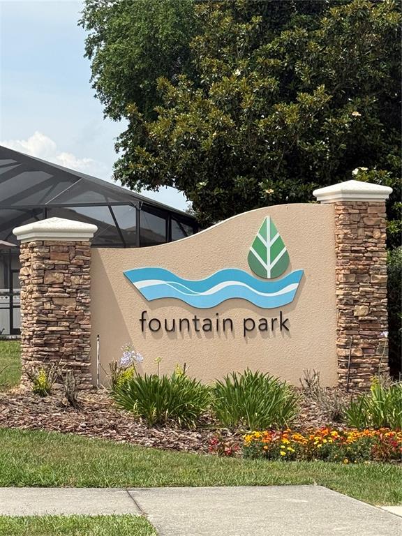 A stone-pillared monument sign for Fountain Park stands in a landscaped yard — 8519 RINDGE ROAD, POLK CITY, FL