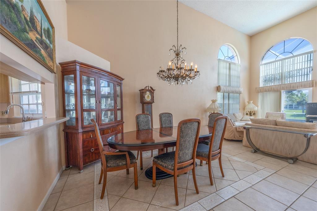 A dining room with a wooden table, chairs, a hutch, and a tall grandfather clock — 29 CHEROKEE COURT W, PALM COAST, FL