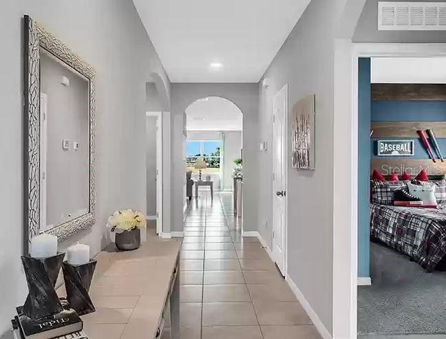 A hallway with a mirror and console table leads toward an open living area — 3820 SWANFALLS TERRACE, SANFORD, FL