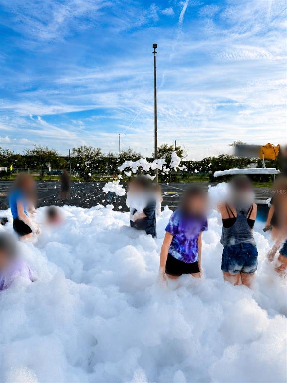 People play in a large pile of foam in an outdoor parking lot — N/A N/A, OCALA, FL