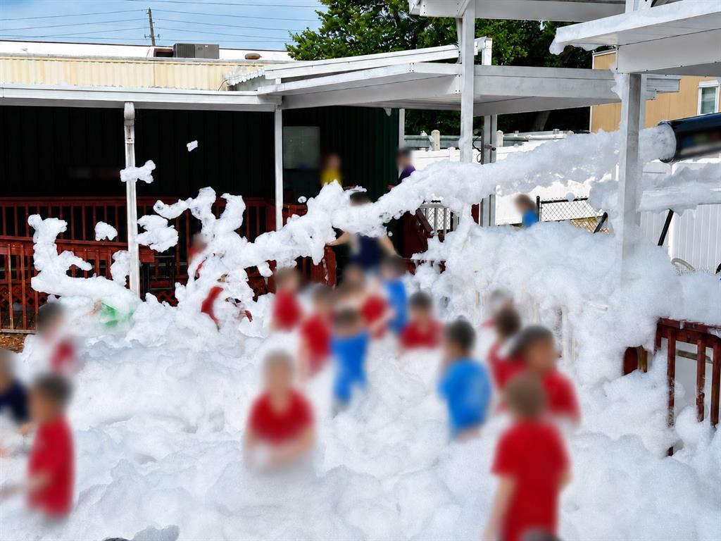 Children play in a large pile of foam under a covered outdoor patio area — N/A N/A, OCALA, FL
