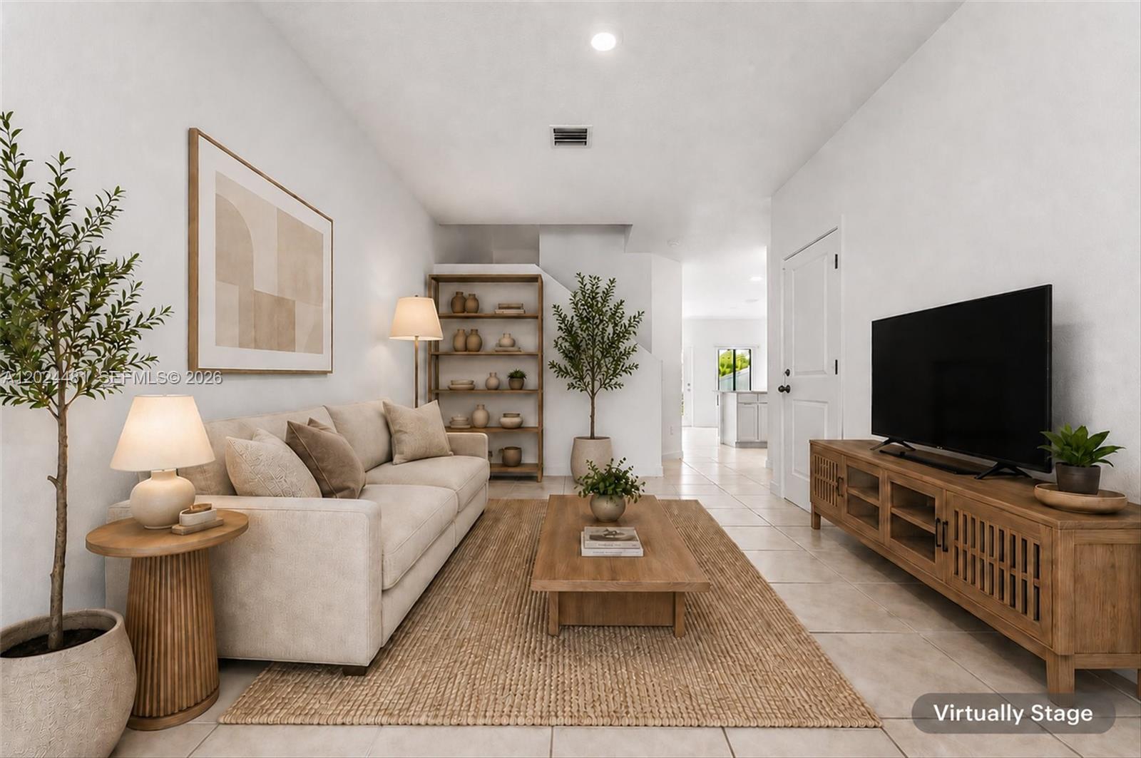 A living room features a beige sofa, wooden coffee table, media console, and a bookshelf — 4825 Dillion St, Lake Worth FL 33463, LAKE WORTH, FL