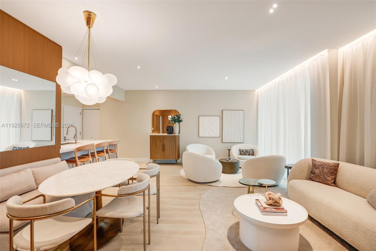 A living area features four white armchairs arranged around a small table on a rug — 31 SE 5th St # 3921, Miami FL 33131, MIAMI, FL