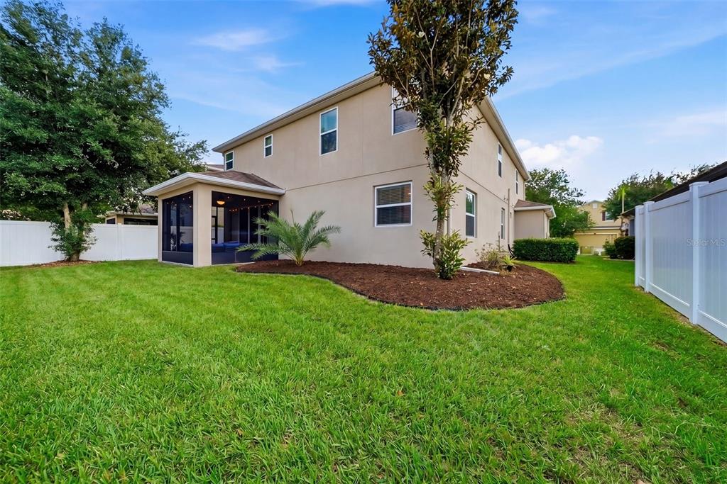 A two-story house with a screened-in porch and a fenced backyard — 24115 SAN GIOVANNI DRIVE, LAND O LAKES, FL