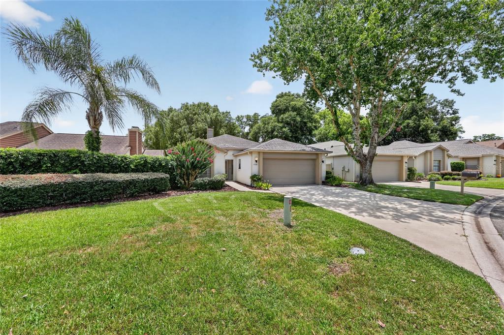 A single-story house with a two-car garage, a concrete driveway, and a large front lawn — 4588 NE 4TH STREET, OCALA, FL