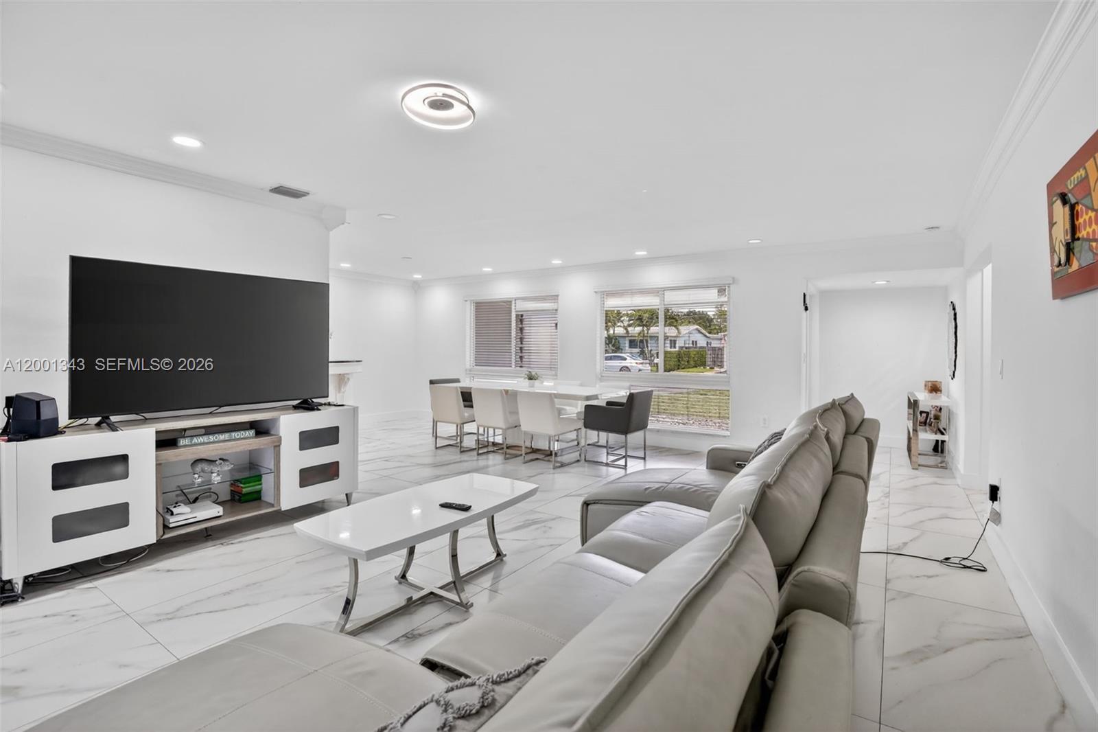 A bright living and dining area features white marble floors, a large television, and furniture — 9280 SW 55th Ct, Cooper City FL 33328, COOPER CITY, FL