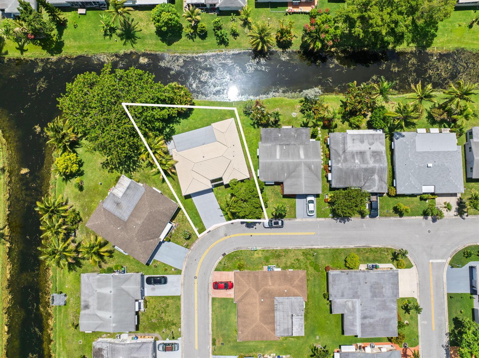 An aerial view shows a single-family home with a white outline on a corner lot — 1550 NW 70th Terrace, Margate FL 33063, MARGATE, FL