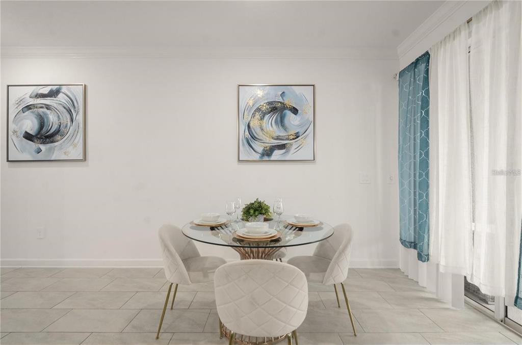 A dining area features a glass-topped table, four upholstered chairs, and two abstract wall paintings — 4363 SCENE LN, KISSIMMEE, FL