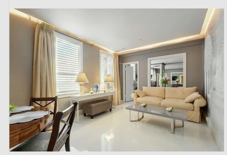 A living and dining area with beige furniture, a grey coffee table, and light flooring — 235 Sunrise Avenue # 2026, Palm Beach FL 33480, PALM BEACH, FL