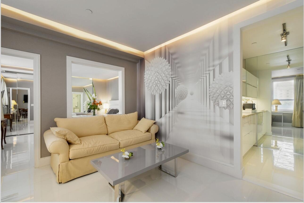 A living room features a beige sofa, a gray coffee table, and a geometric wall mural — 235 Sunrise Avenue # 2026, Palm Beach FL 33480, PALM BEACH, FL