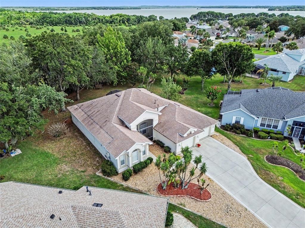 An aerial view shows a suburban house with a tile roof and a concrete driveway — 2852 CAPE HORN COURT, TAVARES, FL