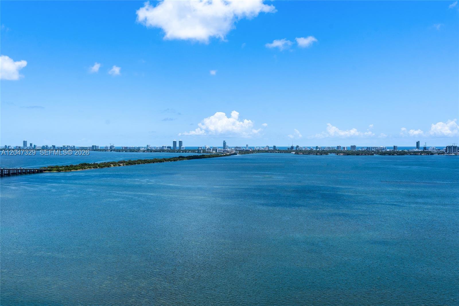 An aerial view shows a wide expanse of blue water with a distant city skyline — 600 NE 27th St # 2904, Miami FL 33137, MIAMI, FL