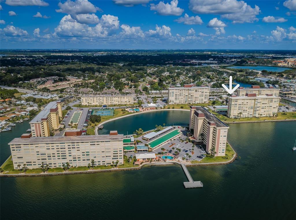 An aerial view of a waterfront apartment complex with multiple buildings and a swimming pool — 4525 COVE CIRCLE UNIT 604, ST PETERSBURG, FL