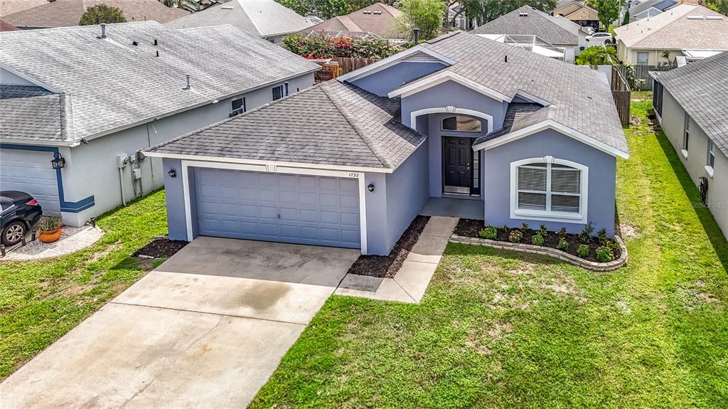 An aerial view of a blue single-story house with a two-car garage and driveway — 1732 HULETT DRIVE, BRANDON, FL