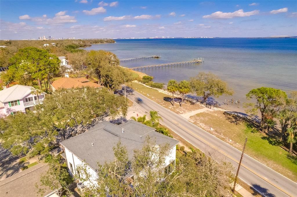 An aerial view of a coastal house, a road, and a wooden pier extending into water — 2802 NORTHPOINTE LANE, TAMPA, FL