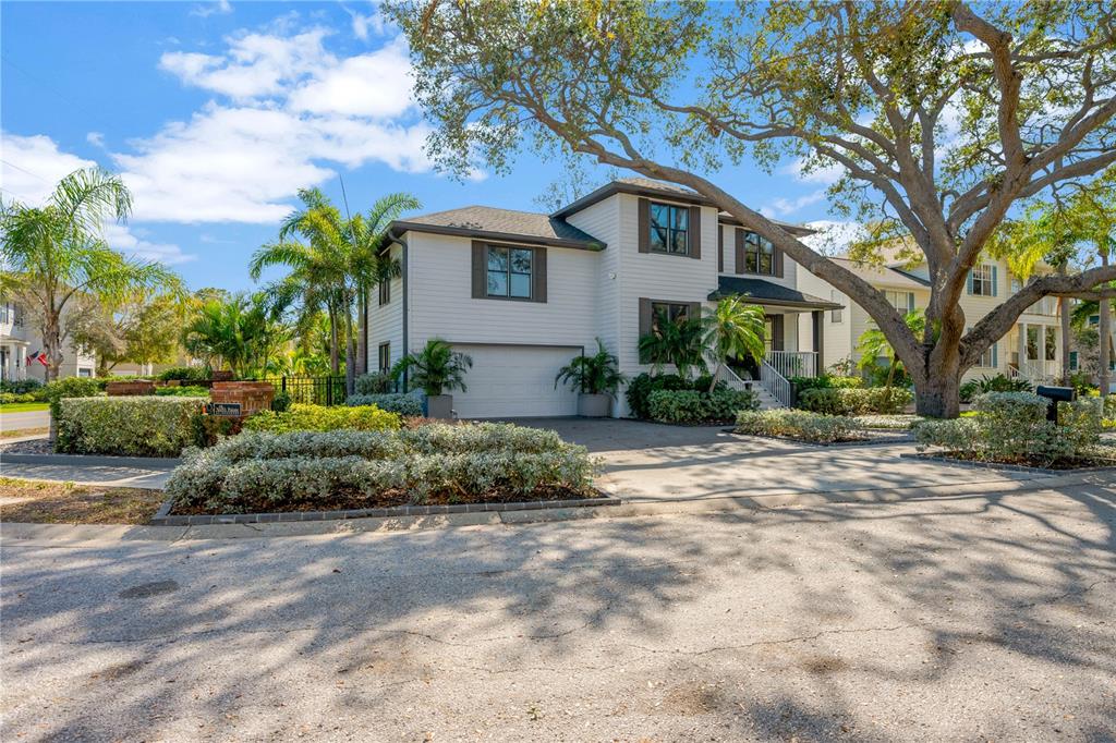 A two-story house with light siding, a two-car garage, and a large tree in front — 2802 NORTHPOINTE LANE, TAMPA, FL