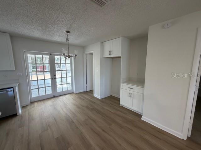 An interior view of a room with light wood flooring, white walls, and a window — 3736 PINE CIRCLE, LAKE WALES, FL
